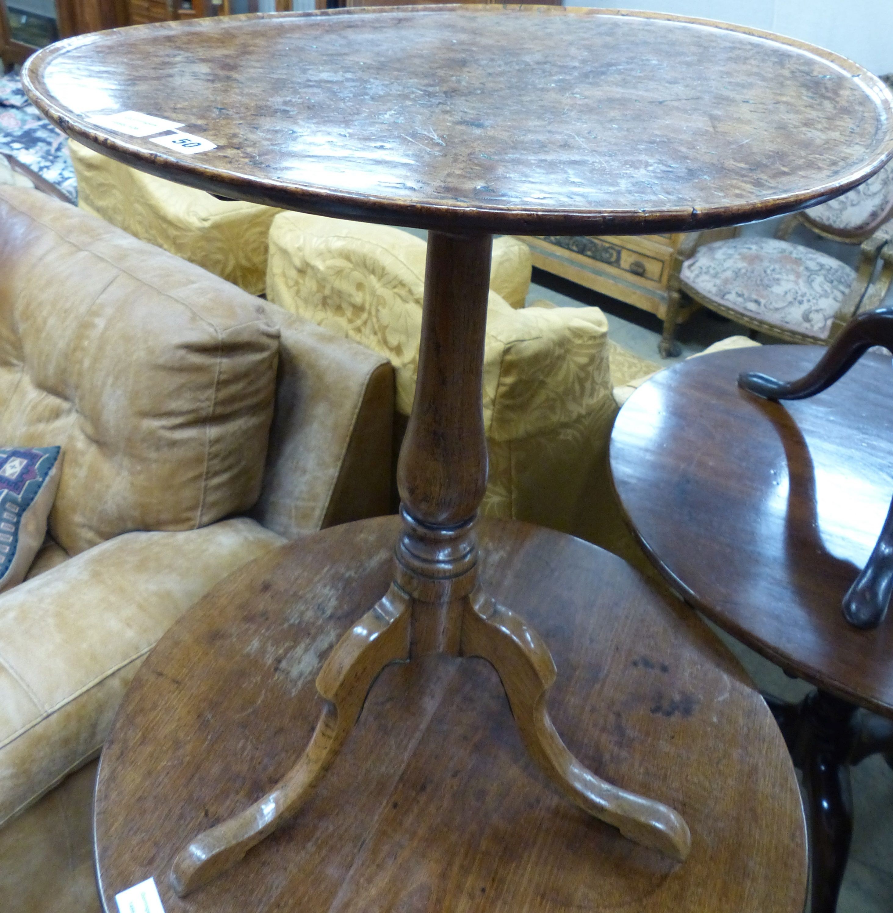 A George III oak and pollard oak circular tilt top tripod tea table (warped) Dia 57 H 67 cms.